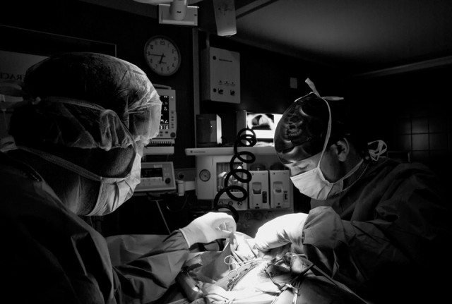 Two surgeons performing abdominal surgery